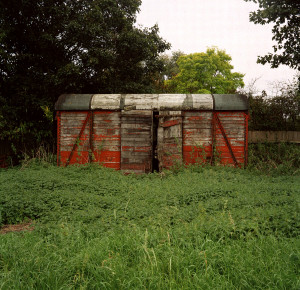red shed, red, shed,photography, photograph, Phill Wilkinson, art, fine art, colour, picture, derelict, peeling paint, minimal, forgotten, field, paint,